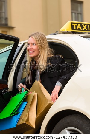 Young woman gets out of taxi, she has reached her destination