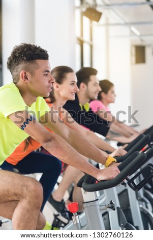 Group of people exercising on bicycle at the fitness gym