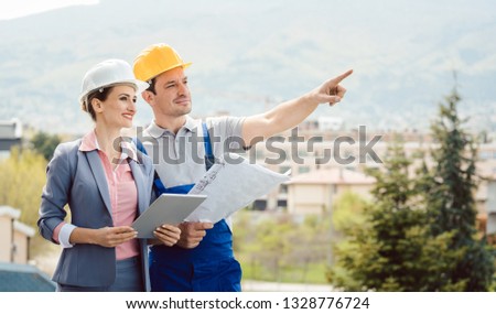 Architect and builder developing ideas for construction project at site