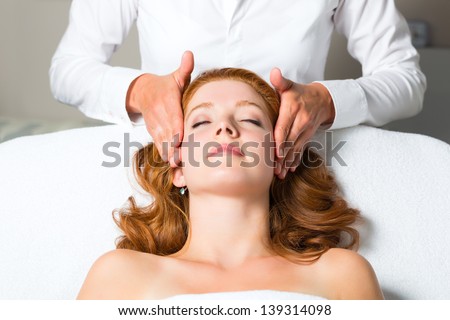 Wellness - woman getting massage in Spa, it is a massage for the head or face