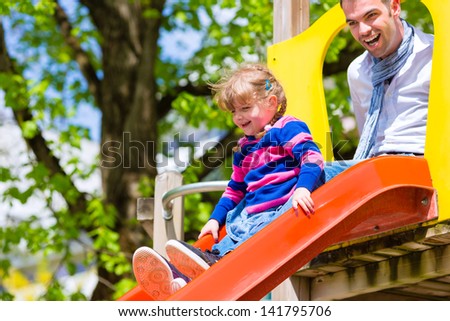 Family - Father and daughter playing on a jungle gym