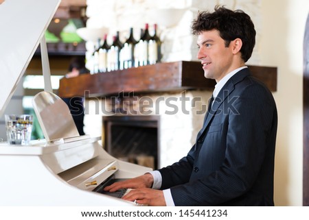 Pianist on a piano creates a beautiful musical Atmosphere in a fine dining restaurant