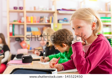Education - Pupils at primary or elementary school doing their homework or having a school test