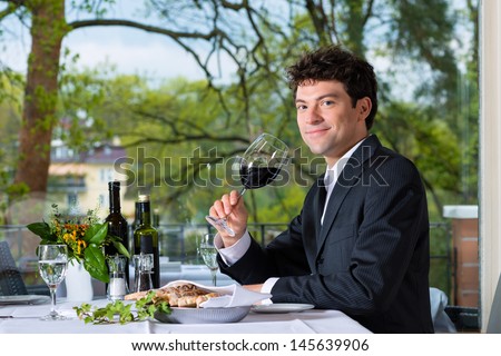 Businessman has business lunch in a fine dining restaurant