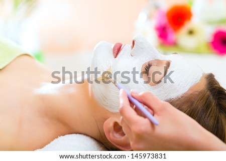Wellness - woman receiving nurturing facial mask in spa for moist and clean skin