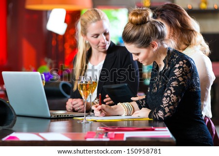 Young women or colleagues in cafe or restaurant, they working together and having fun, they are a good team