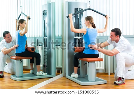 Patient at the physiotherapy or physical therapy doing exercises with her therapist Patient at the physiotherapy or physical therapy doing exercises with her therapist