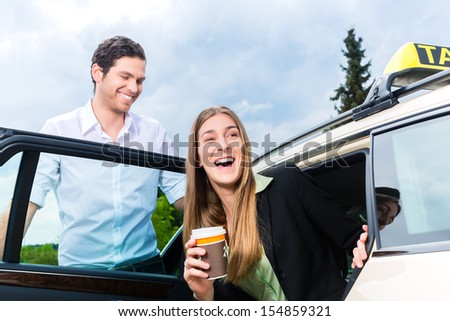 Young businesswoman gets out of taxi, she holding a cup of coffee