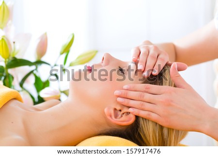 Wellness - woman receiving head or face massage in spa