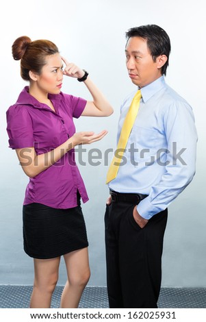 Angry argument among colleagues in an Asian business office
