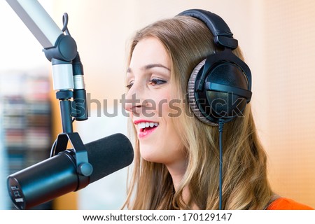 Female presenter or host in radio station hosting show for radio live in Studio