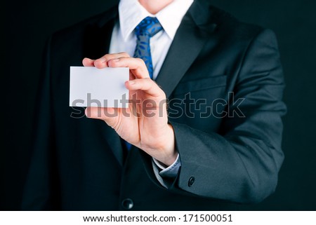 Business man or manager in suit hand over empty business card to socialize