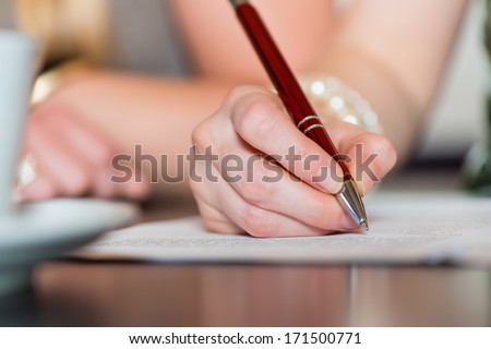 Young women or colleagues working in a cafe or restaurant, on some documents or contract, someone sign a agreement