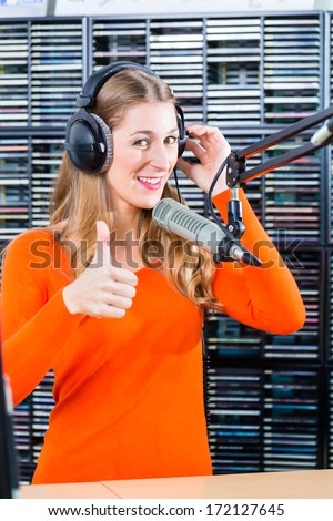 Female Presenter or host in radio station hosting show for radio live in Studio