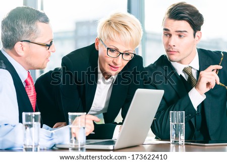 Business - meeting in office, the businesspeople with boss and team are discussing a document on Laptop computer