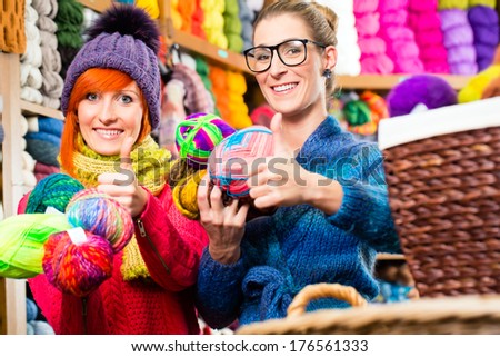 Young women buying colorful wool and yarn for their hobby in knitting fashion shop