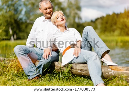 happy senior couple outdoors in spring arm in arm deeply in love