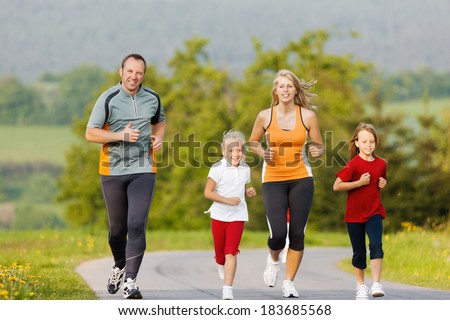 Family jogging for sport for fitness outdoors with the kids