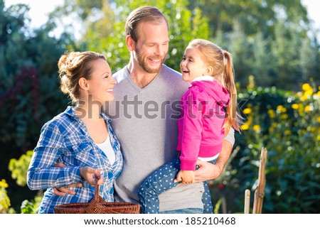 Mother, father and daughter in garden