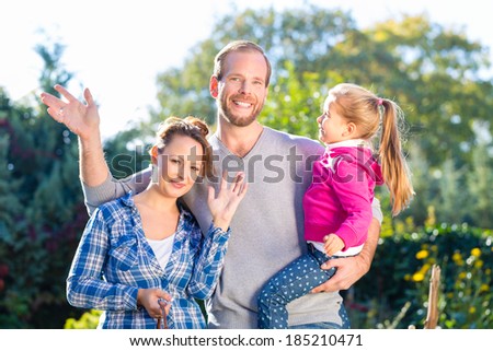Mother, father and daughter in garden