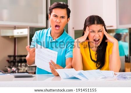 Young Asian handsome couple fighting and shouting because of financial dept and unpaid bills due