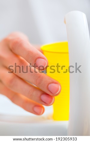 Patient rinse mouth with a cup of water at dentist
