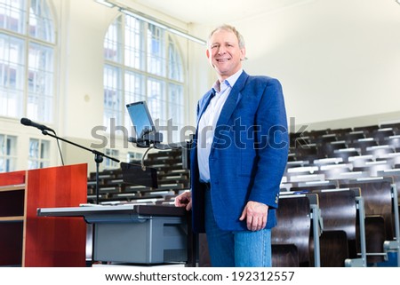 College professor giving lecture and standing at desk
