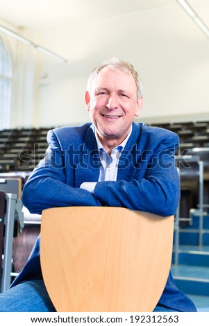College professor giving lecture and standing at desk