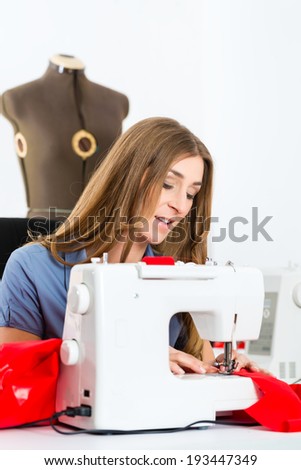 Freelancer - Fashion designer or Tailor working on a design or draft, she sews with a sewing machine