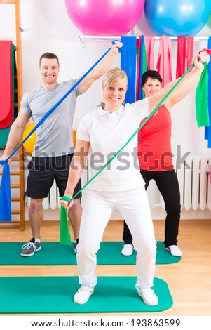 Patients at the physiotherapy doing physical exercises with therapist