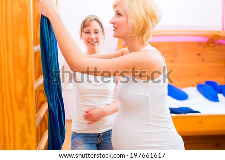 Midwife doing pregnancy gymnastics in her practice