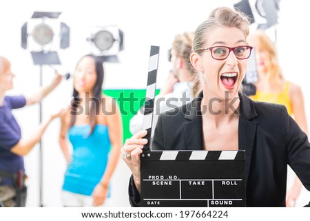 Woman with take clap or board on Film Set of video production for TV, television, news or commercial