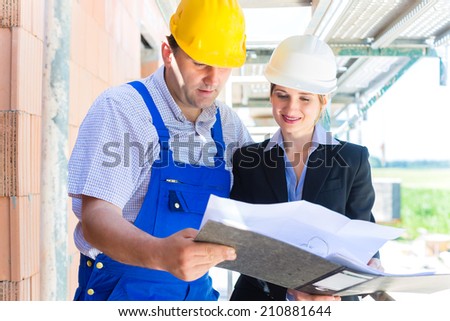 Team or architect and builder or worker with helmets controlling or discuss  construction plan or blueprints of building site