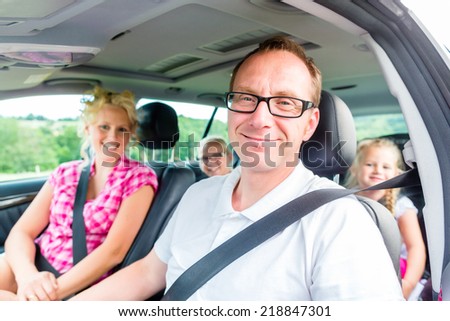 Family driving in car with seat belt fastened