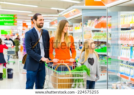 Family with shopping cart in supermarket store