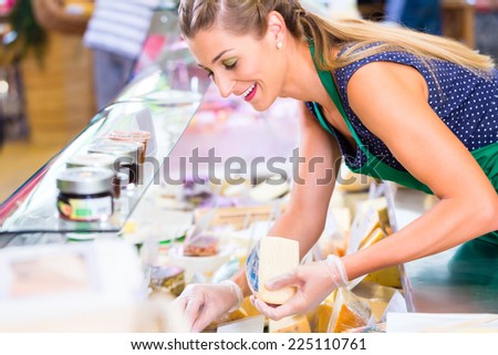 Saleswoman working at counter in groceries shop