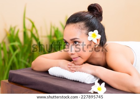 Indonesian Asian woman in wellness beauty day spa looking relaxed