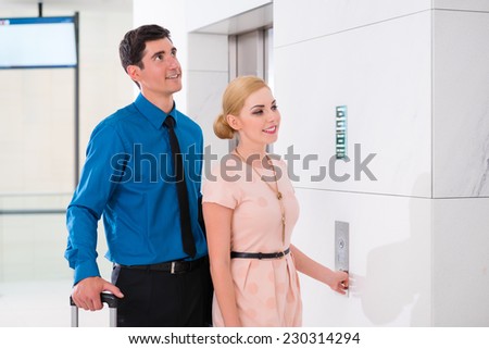 Couple waiting for hotel elevator or lift