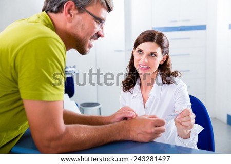 Doctors nurse with telephone in front desk making appointment with patient
