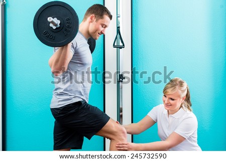 Patient at the physiotherapy doing physical exercises using bar bell