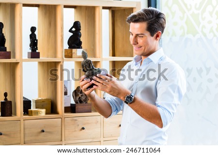 Man at cabinet in furniture store showroom