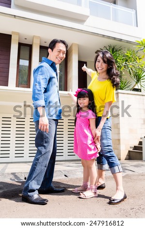 Chinese Family in front of house in residential area in Asia