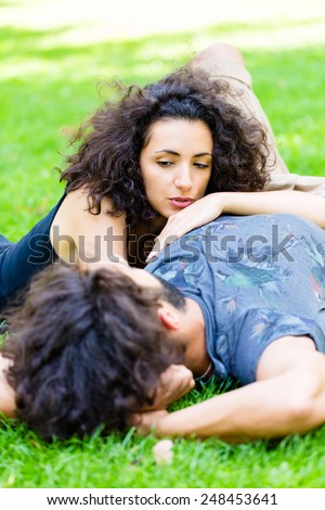 Couple, Latin man and woman, girlfriend and boyfriend, on meadow sleeping in summer