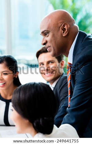 Indian Business man leading team meeting of diversity people in office