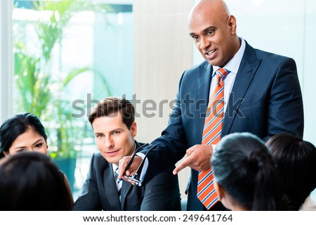 Indian Business man leading team meeting of diversity people in office