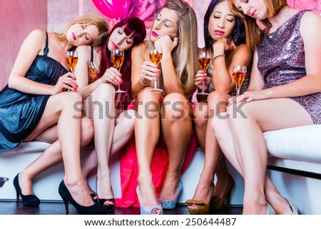 Women partying with champagne in club until morning rises, they are tired