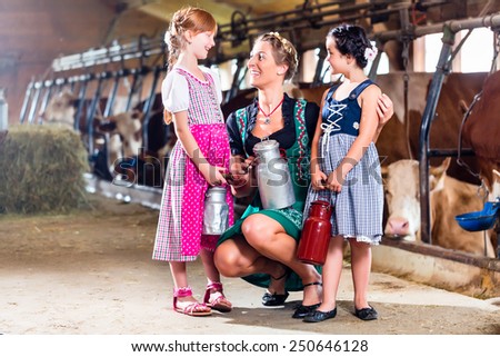 Bavarian family with milk can on cow farm