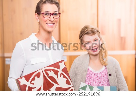 Family with cement floor tiles in home improvement store