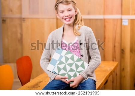 Child with cement floor tiles in home improvement store