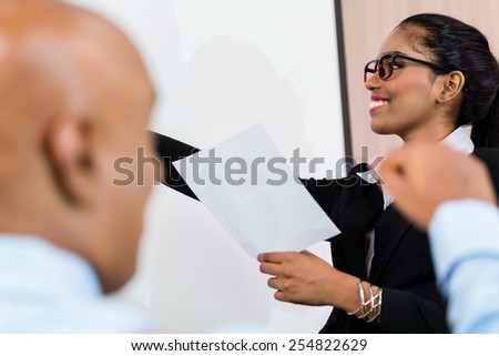 Indian business woman having presentation in front of her business team